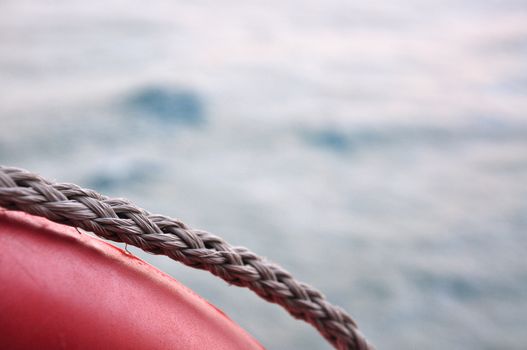Red life buoy on sea background photographed from a boat