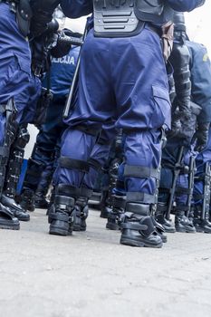 Unit of police special forces in riot gear waiting for orders.