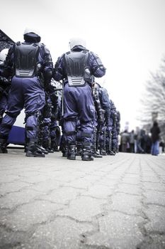 Unit of police special forces in riot gear waiting for orders.