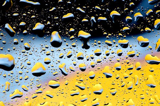 Black blue yellow background with water drops pattern.