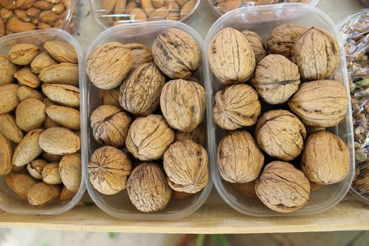 Walnuts and Almonds in plastic boxes. Market in Aix-En-Provence