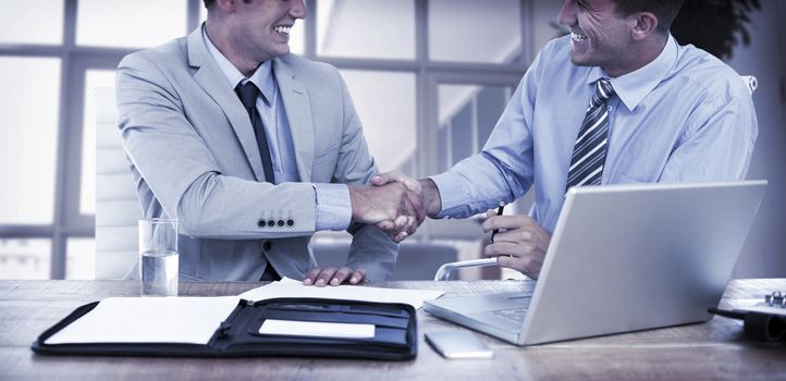 Business partners shaking hands in the office