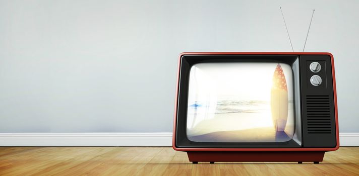 Retro tv against surf board standing on the sand