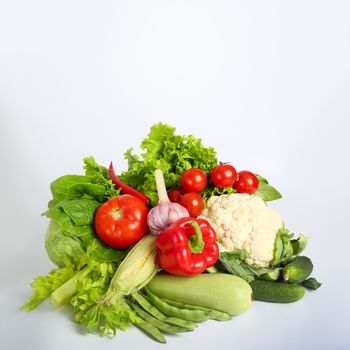 Pile of colorful fresh vegetables on white background