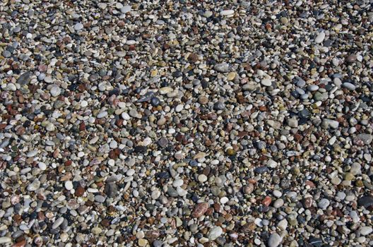 wet Pebbly beach stone background in Mediterranean sea beach, Rhodes, Greece