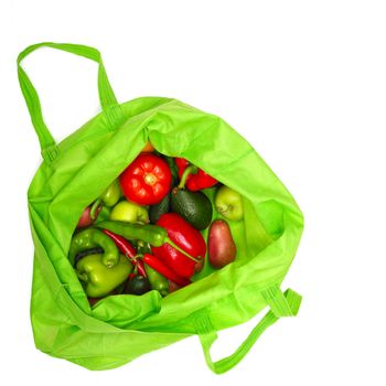 Green shopping bag with fresh vegetables close-up
