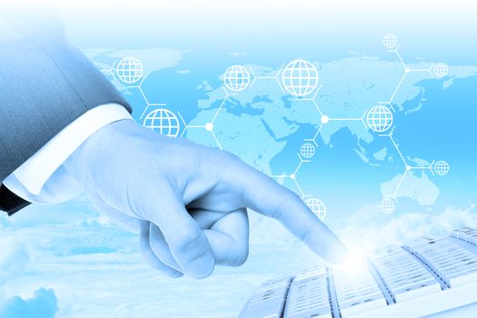 Businessmans left hand touching keyboard on abstract blue background with world map
