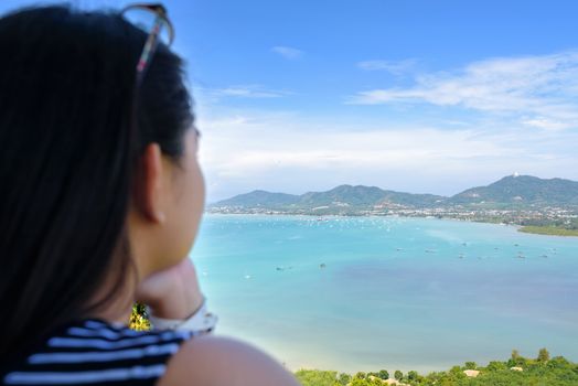 Back side the women tourist looking at beautiful landscape of sea and island on Khao Khad mountain viewpoint famous attractions in Phuket Province, Thailand