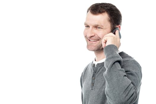 Sideways of casual man talking on cell phone