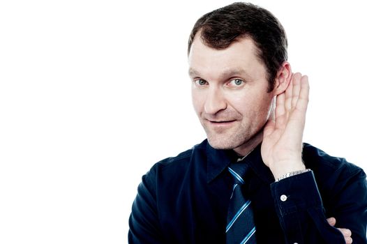Relaxed businessman with hand behind ear