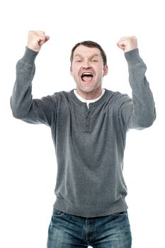 Middle aged man celebrating success with arms up