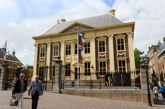 The Hague, Netherlands - May 8, 2015: Tourists visit Mauritshuis Museum in The Hague, Netherlands. The museum houses the Royal Cabinet of Paintings which consists of 841 objects, mostly Dutch Golden Age paintings.