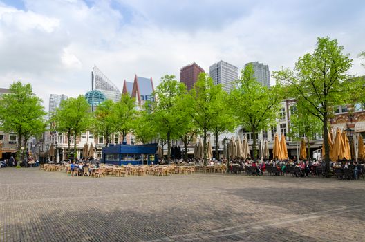 The Hague, Netherlands - May 8, 2015: People at Het Plein in The Hague's city centre, with the statue of William the Silent in the middle. on May 8, 2015.