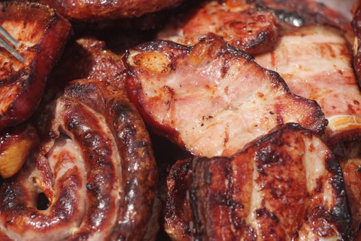 Barbecuing meat on charcoal fire closeup image.
