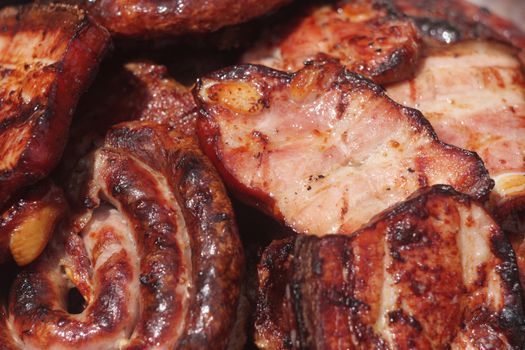 Barbecuing meat on charcoal fire closeup image.
