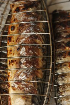 Barbecuing fish (mackerel) on charcoal fire closeup image.
