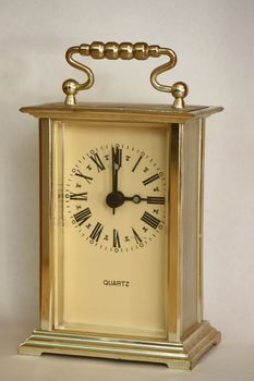 Table clock, showing three o'clock.