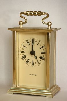Table clock showing 5 o'clock.