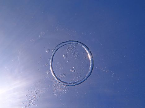 Bubble ring from the air rises upwards the sun.