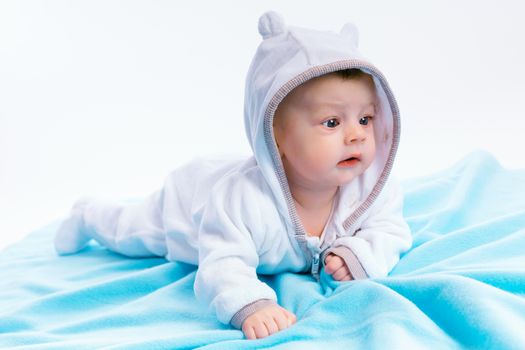 baby in the hood on a blue blanket