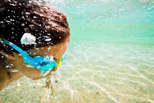 Fast swim underwater in a green clear sea.