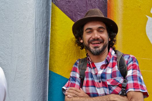 Sao Paulo, Brazil July 18, 2015: Graffiti artist Eduardo Kobra posing in front of his mural about recycling in Sao Paulo Brazil.