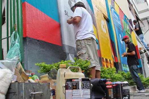 Sao Paulo, Brazil July 18, 2015: Graffiti in development from artist Eduardo Kobra staff in a mural about recycling in Sao Paulo Brazil.