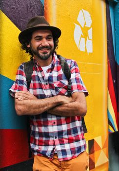 Sao Paulo, Brazil July 18, 2015: Graffiti artist Eduardo Kobra posing in front of his mural about recycling in Sao Paulo Brazil.