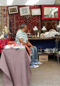 Sao Paulo, Brazil, July 18 2015: Unidentified elderly man in the traditional antique objects market that has been held all Saturdays in Benedito Calixto square in Sao Paulo Brazil. 