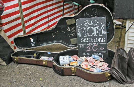 Sao Paulo, Brazil, July 18 2015: Detail of music contribution for a band in the traditional antique objects market that has been held all Saturdays in Benedito Calixto square in Sao Paulo Brazil. 