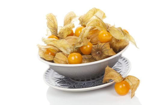 Physalis, groundcherries in bowl isolated on white background. Tropical healthy fruit eating.