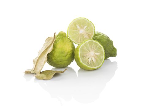 Delicious ripe bergamot fruit with dry leaves isolated on white background. Culinary healthy tropical fruit.