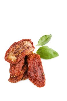 Sundried tomato with fresh basil herbs isolated on white background. Culinary italian eating.