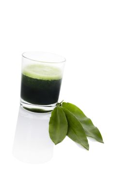 Green juice made from wild garlic with fresh wild garlic leaf isolated on white background. Spring detox, modern minimal style image. 