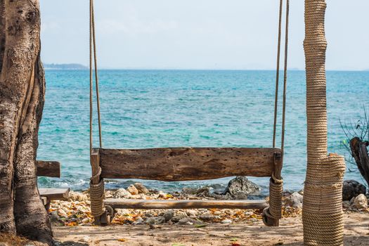 Wood swing on the beach near sea