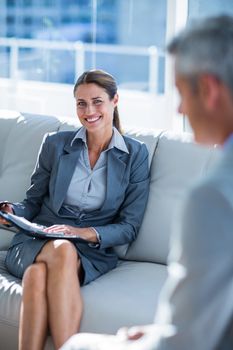 Business people speaking together on couch in office 