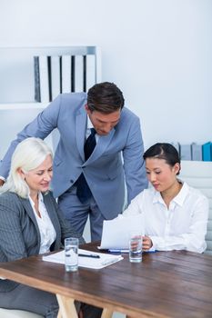 Business people looking at documents in office 