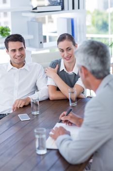 Casual business people speaking together in office