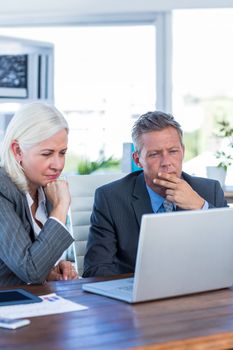 Business people working on laptop computer in office