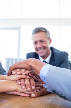 Business people joining hands together in the office