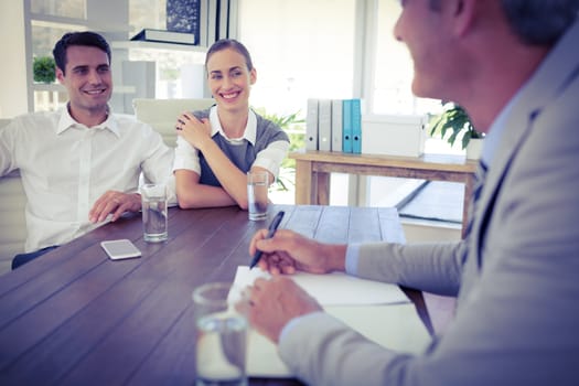 Casual business people speaking together in office