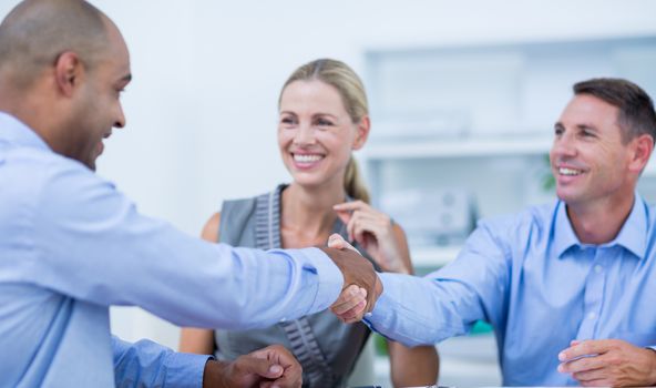 Business partners shaking hands on the office 