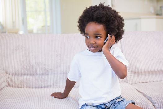 Portrait of a little boy using technology at home on bedroom