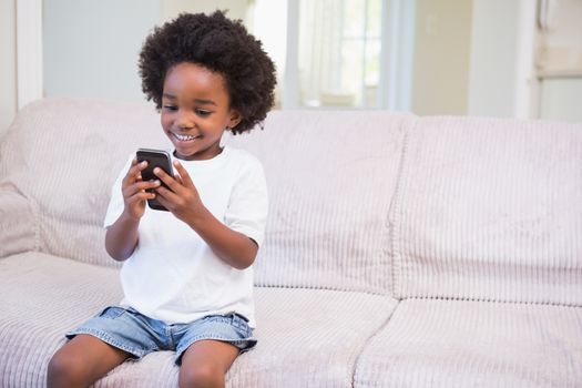 Portrait of a little boy using technology at home on bedroom