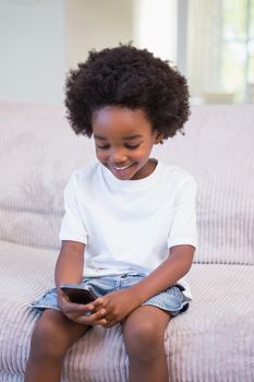 Little boyusing a technology at home in bedroom 