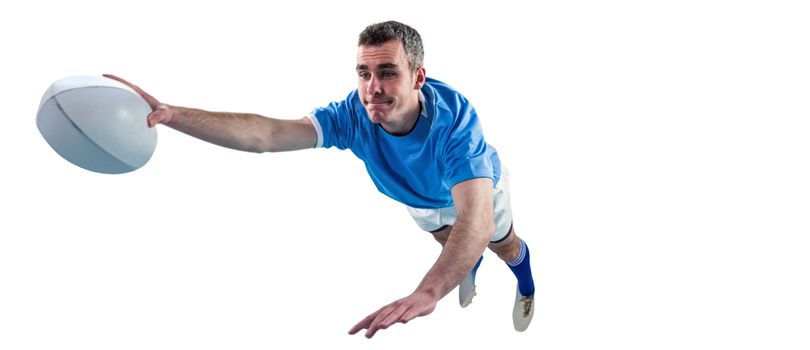 A determined rugby player scoring a try