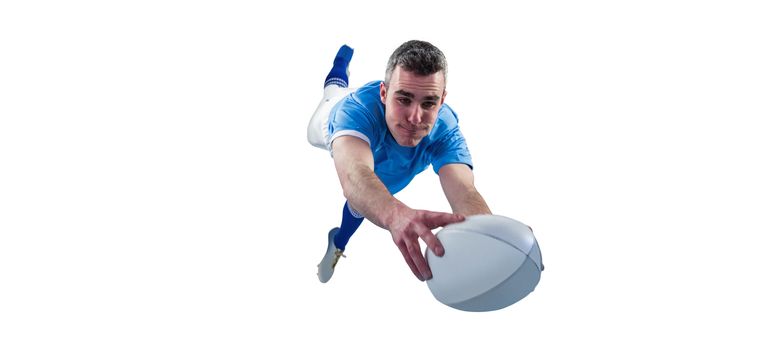 A determined rugby player scoring a try