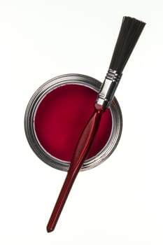 Tin of red emulsion paint and a paintbrush
