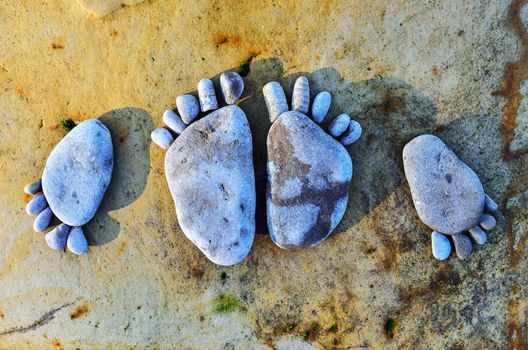 Four stone footprints in the sandy beach