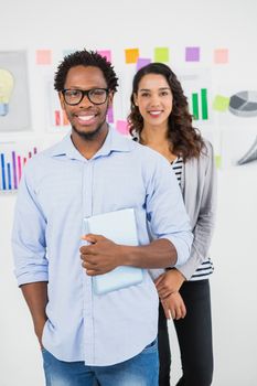 Young smiling business people looking at the camera in the office